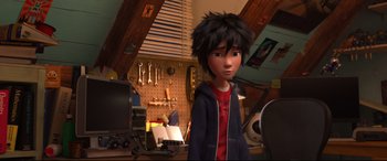 Movie still from “Big Hero 6” (2014), directed by Chris Williams – A boy standing in front of a computer desk; Medium shot, High angle
