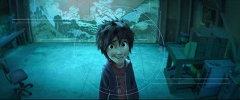 Movie still from “Big Hero 6” (2014), directed by Chris Williams – A young boy is smiling for the camera in front of an aquarium; Medium shot, Overhead angle