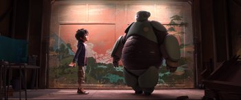 Movie still from “Big Hero 6” (2014), directed by Chris Williams – A boy standing next to a giant robot in front of a mural; Wide shot, Low angle