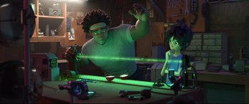 Movie still from “Big Hero 6” (2014), directed by Chris Williams – A man and a woman are standing in front of a table; Medium shot, Low angle