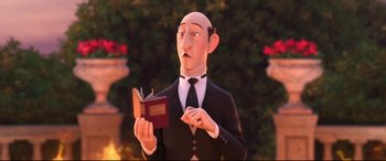 Movie still from “Big Hero 6” (2014), directed by Chris Williams – A man in a suit and tie holding an open book; Close Up shot, Over the shoulder angle