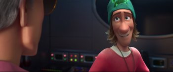 Movie still from “Big Hero 6” (2014), directed by Chris Williams – A man with a green hat is smiling for the camera; Close Up shot, Over the shoulder angle