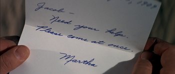 Movie still from “Big Jake” (1971), directed by George Sherman – A handwritten letter with a hand writing it; Extreme Close Up shot, Overhead angle