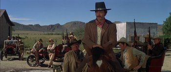 Movie still from “Big Jake” (1971), directed by George Sherman – A man on a horse in a cowboy outfit; Medium shot, Low angle