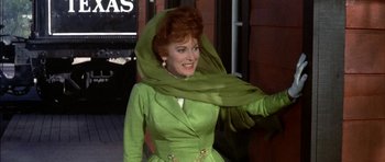 Movie still from “Big Jake” (1971), directed by George Sherman – An older woman wearing a green dress and a green head scarf; Medium shot, Low angle