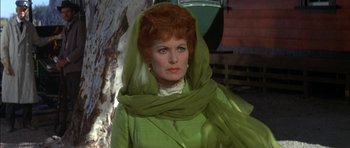 Movie still from “Big Jake” (1971), directed by George Sherman – An older woman in a green dress and a green scarf; Close Up shot, Low angle