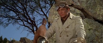 Movie still from “Big Jake” (1971), directed by George Sherman – A man wearing a hat and a jacket holding a light; Close Up shot, Low angle