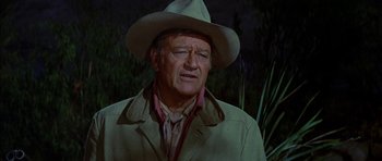 Movie still from “Big Jake” (1971), directed by George Sherman – A person wearing a hat; Close Up shot, Over the shoulder angle