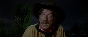 Movie still from “Big Jake” (1971), directed by George Sherman – A person wearing a cowboy hat; Close Up shot, Over the shoulder angle