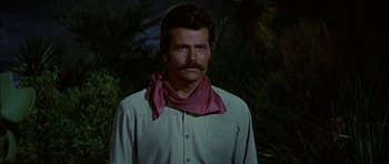 Movie still from “Big Jake” (1971), directed by George Sherman – A man with a mustache wearing a neck scarf; Close Up shot, Low angle