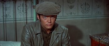 Movie still from “Big Jake” (1971), directed by George Sherman – A man wearing a hat and a leather jacket; Close Up shot, High angle