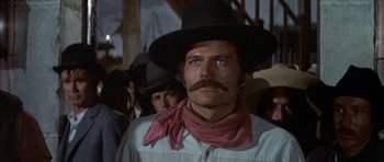 Movie still from “Big Jake” (1971), directed by George Sherman – A person wearing a cowboy hat; Close Up shot, Low angle