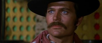 Movie still from “Big Jake” (1971), directed by George Sherman – A person wearing a cowboy hat; Close Up shot, Low angle