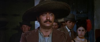 Movie still from “Big Jake” (1971), directed by George Sherman – A person wearing a cowboy hat; Close Up shot, Low angle