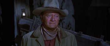 Movie still from “Big Jake” (1971), directed by George Sherman – A person wearing a cowboy hat; Close Up shot, Over the shoulder angle