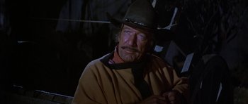 Movie still from “Big Jake” (1971), directed by George Sherman – A man in a cowboy hat and a tie; Close Up shot, Low angle