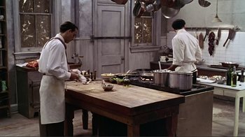 Movie still from “Big Night” (1996), directed by Stanley Tucci – Two men working in a kitchen preparing food; Wide shot, High angle