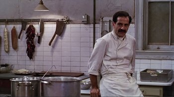 Movie still from “Big Night” (1996), directed by Stanley Tucci – A man standing in front of a pot in a kitchen; Medium shot, Low angle