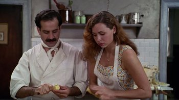 Movie still from “Big Night” (1996), directed by Stanley Tucci – A man and a woman peeling an apple in a kitchen; Medium shot, High angle