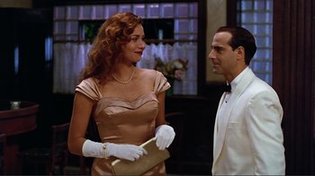 Movie still from “Big Night” (1996), directed by Stanley Tucci – A man and a woman wearing white gloves; Medium shot, Over the shoulder angle