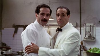 Movie still from “Big Night” (1996), directed by Stanley Tucci – A couple of men standing next to each other; Medium shot, Low angle
