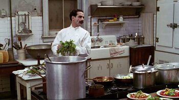 Movie still from “Big Night” (1996), directed by Stanley Tucci – A man standing in a kitchen with a large pot; Medium shot, High angle