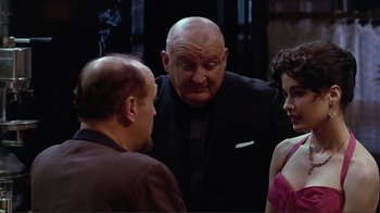 Movie still from “Big Night” (1996), directed by Stanley Tucci – A group of people standing next to each other in a room; Medium shot, Over the shoulder angle