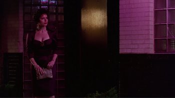 Movie still from “Big Night” (1996), directed by Stanley Tucci – A woman standing in front of a brick building; Medium shot, Low angle