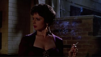 Movie still from “Big Night” (1996), directed by Stanley Tucci – A woman in a purple dress smoking a cigarette; Close Up shot, Low angle