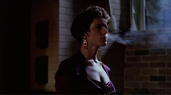 Movie still from “Big Night” (1996), directed by Stanley Tucci – A woman in a purple jacket and gold earrings; Close Up shot, Low angle