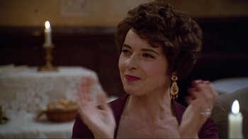 Movie still from “Big Night” (1996), directed by Stanley Tucci – An older woman wearing a purple dress clapping her hands; Close Up shot, Low angle
