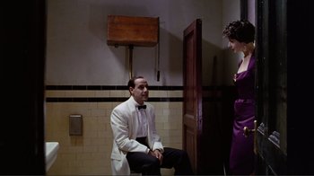 Movie still from “Big Night” (1996), directed by Stanley Tucci – A man and a woman are sitting in a bathroom; Medium shot, Low angle