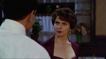 Movie still from “Big Night” (1996), directed by Stanley Tucci – A woman in a purple dress looking at a man in a purple suit; Close Up shot, Over the shoulder angle