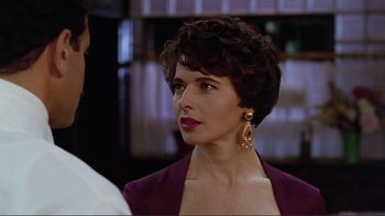 Movie still from “Big Night” (1996), directed by Stanley Tucci – A person wearing a suit and tie; Close Up shot, Over the shoulder angle
