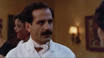 Movie still from “Big Night” (1996), directed by Stanley Tucci – A person wearing a white shirt; Close Up shot, Low angle