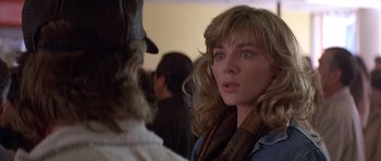 Movie still from “Big Trouble in Little China” (1986), directed by John Carpenter – A person wearing a hat; Close Up shot, Over the shoulder angle