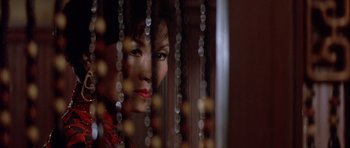 Movie still from “Big Trouble in Little China” (1986), directed by John Carpenter – A person behind a curtain; Close Up shot, Low angle
