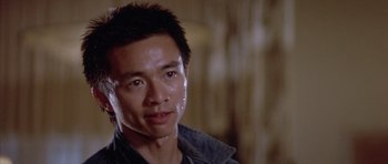 Movie still from “Big Trouble in Little China” (1986), directed by John Carpenter – A person wearing a jacket; Close Up shot, Low angle