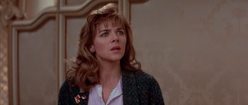 Movie still from “Big Trouble in Little China” (1986), directed by John Carpenter – A person with long hair; Close Up shot, Over the shoulder angle