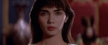 Movie still from “Big Trouble in Little China” (1986), directed by John Carpenter – A woman's face in a white shirt; Close Up shot, Over the shoulder angle
