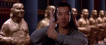 Movie still from “Big Trouble in Little China” (1986), directed by John Carpenter – A man holding his hand up in the air; Close Up shot, Low angle