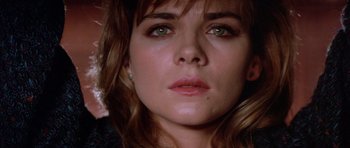 Movie still from “Big Trouble in Little China” (1986), directed by John Carpenter – A woman's face with green eyes; Close Up shot, Low angle