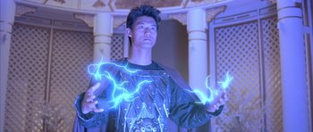 Movie still from “Big Trouble in Little China” (1986), directed by John Carpenter – A young man holding a blue lightning in his hands; Medium shot, Low angle
