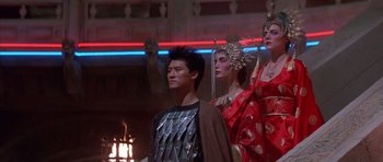 Movie still from “Big Trouble in Little China” (1986), directed by John Carpenter – A group of people standing next to each other in costumes; Medium shot, Low angle