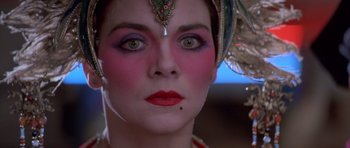 Movie still from “Big Trouble in Little China” (1986), directed by John Carpenter – A woman's face with makeup on; Close Up shot, Over the shoulder angle