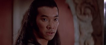 Movie still from “Big Trouble in Little China” (1986), directed by John Carpenter – A person with long black hair; Close Up shot, Low angle