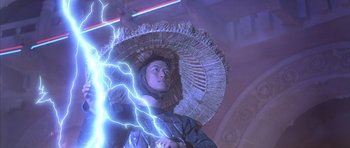 Movie still from “Big Trouble in Little China” (1986), directed by John Carpenter – A man with a large umbrella is standing in front of a lightning strike; Medium shot, Low angle