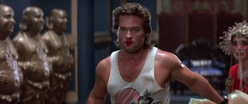 Movie still from “Big Trouble in Little China” (1986), directed by John Carpenter – A person wearing a tank top; Close Up shot, Low angle