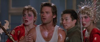 Movie still from “Big Trouble in Little China” (1986), directed by John Carpenter – A group of men standing next to each other; Close Up shot, Over the shoulder angle