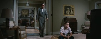 Movie still from “Bigger Than Life” (1956), directed by Nicholas Ray – A man and a boy are in a room together; Wide shot, Low angle